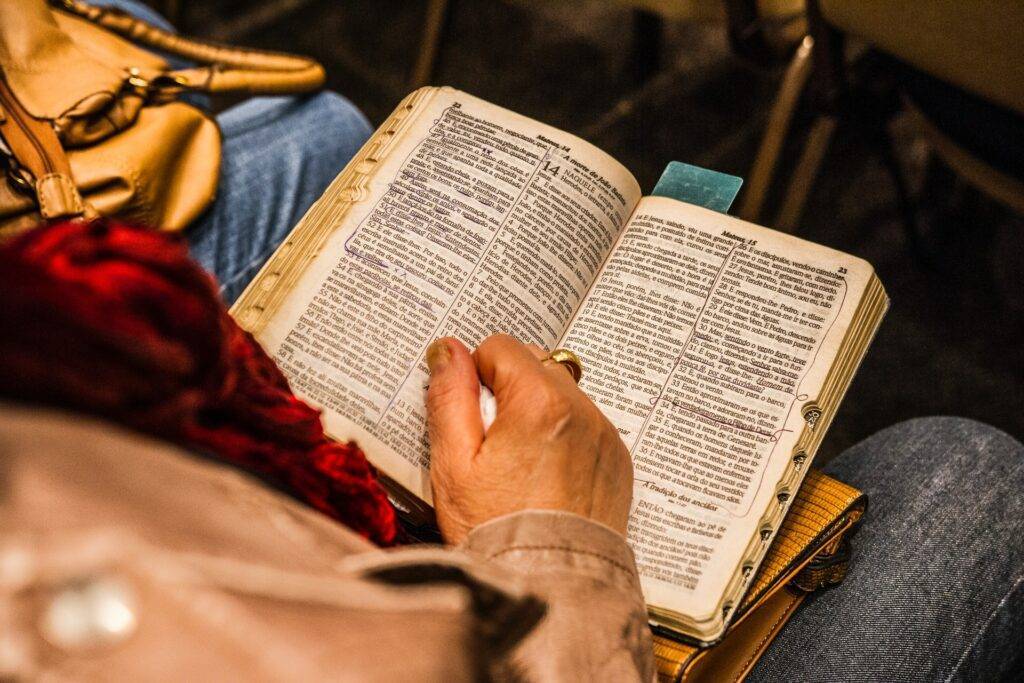 Man reading Bible in Pew